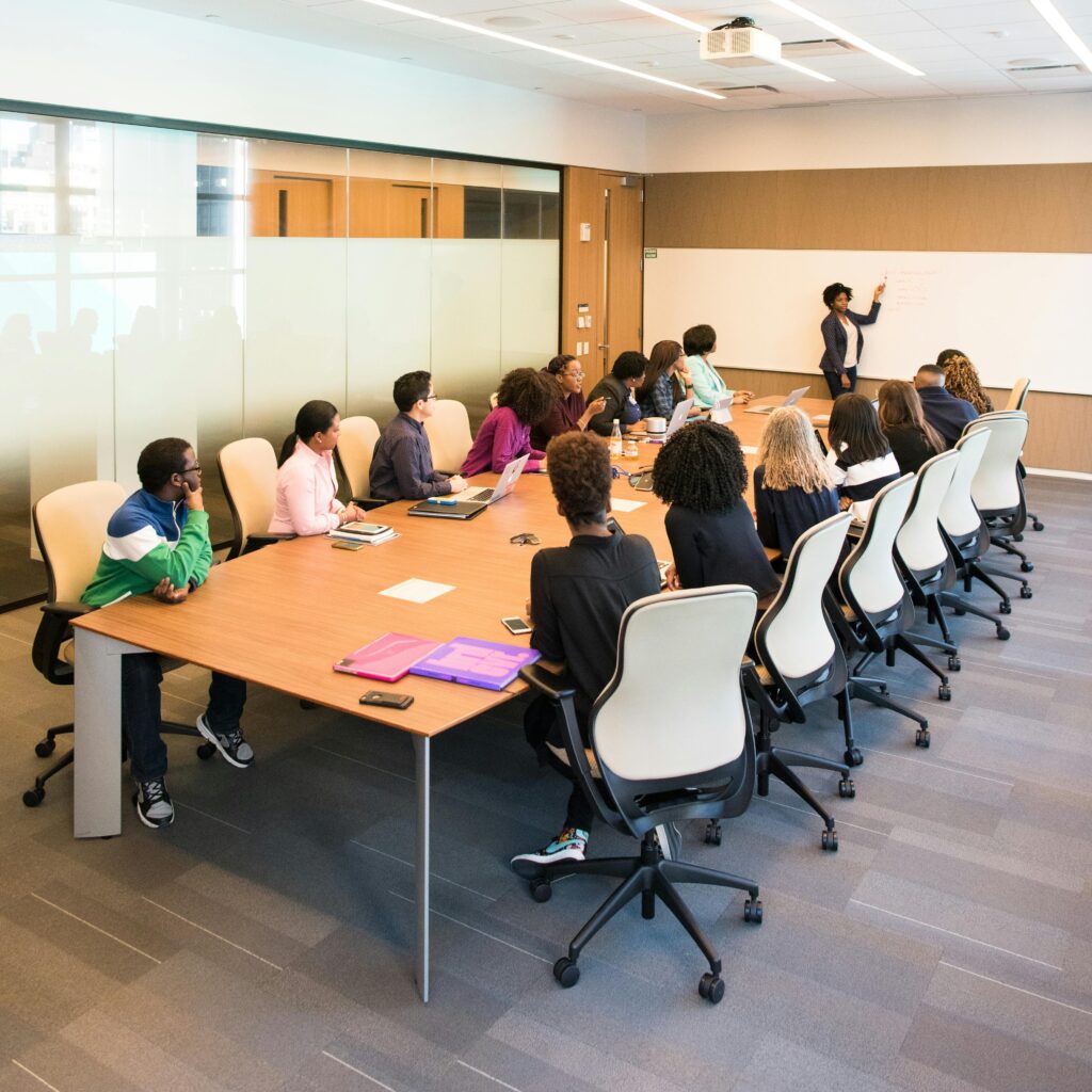 Professional team engaged in a collaborative boardroom meeting with a presentation in progress.